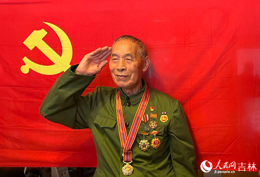 老兵向德明在黨旗下敬禮。人民網記者 李思玥攝